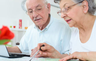 Couple looking at map and laptop